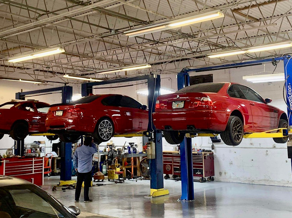 BMW vehicles on lifts inside the workshop