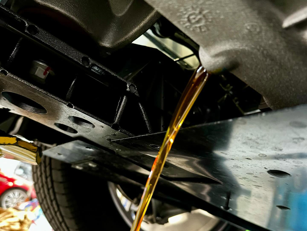 Oil draining from a vehicle during an oil change